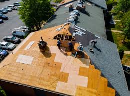 Roof replacement crew working on a large residential roof deck